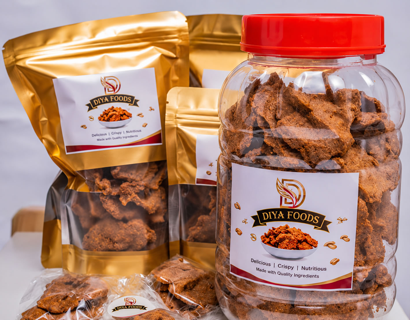 Odiya Foods kuli kuli in branded gold pouches and a resealable jar